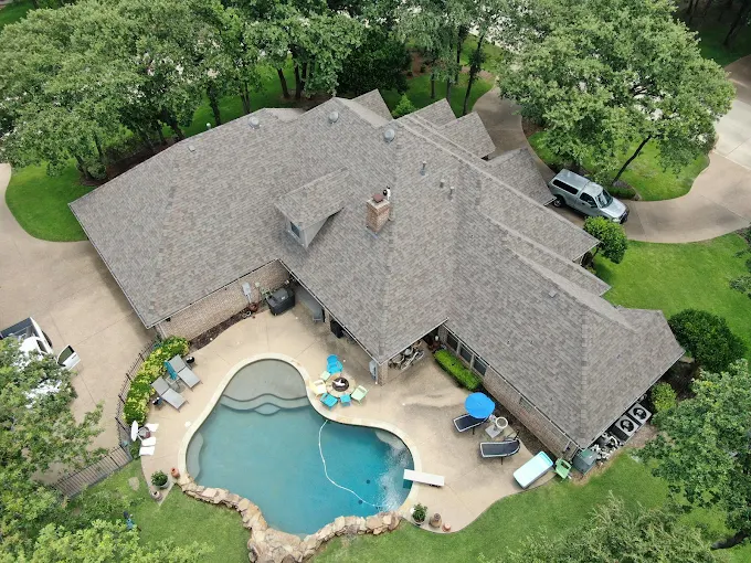 Newly installed architectural shingle roof on a Texas home at sunset